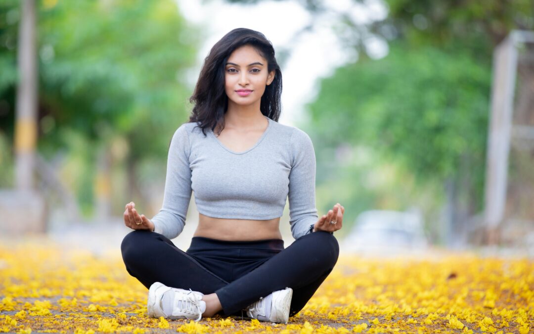 Woman sitting in a yoga pose outdoors