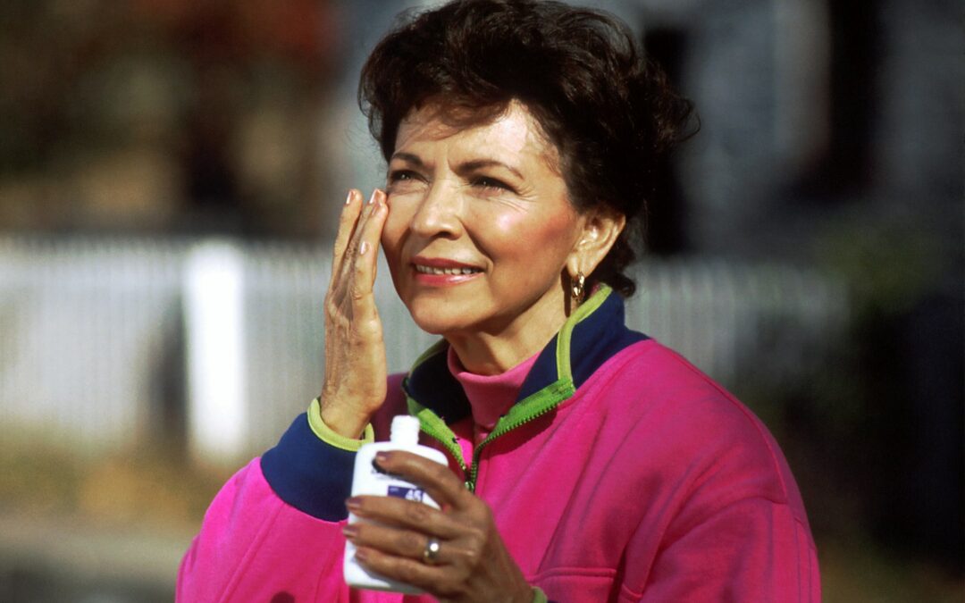 Smiling mature woman in a pink shirt